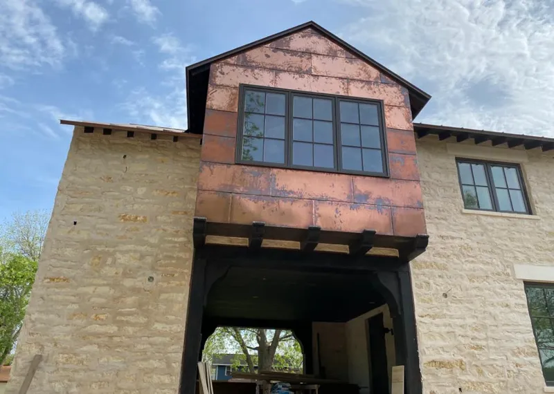 Copper metal panel facade on a stone building for Roof Repair in Sweetwater