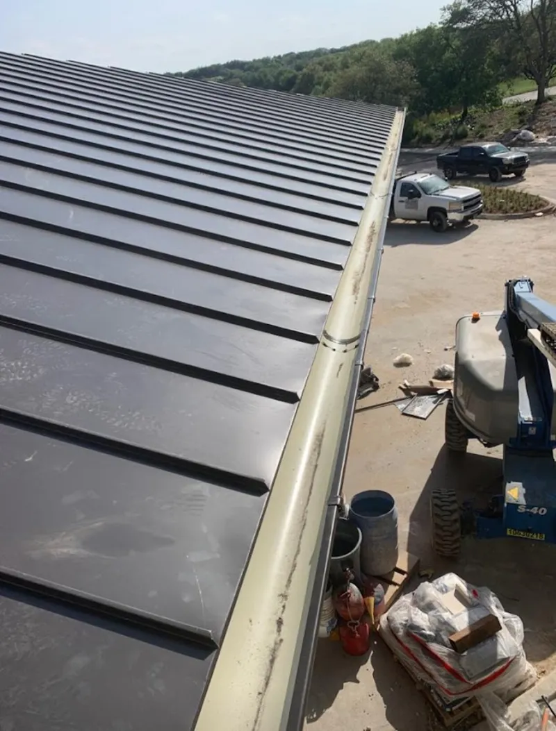 Standing seam panel and gutter detail on a metal roofing jobsite in Sweetwater